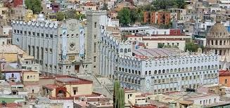 A large old university building in a traditional Mexican town